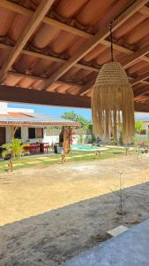 awning of a pavilion with a view of a house at Suite Cajueiro in Barrinha