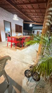 a living room with a table and chairs and plants at Suite Cajueiro in Barrinha