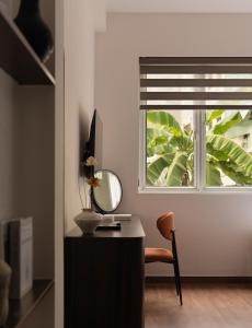 a mirror sitting on a desk next to a window at V Living - Charming Stay in downtown SaiGon in Ho Chi Minh City