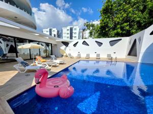 a swimming pool with a pink flamingo float in a house at City Centre Luxury Residence with Pool near Dunya IVF & Beach in Kérynia