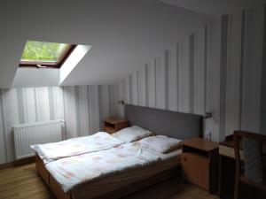 a bedroom with a bed in a room with a window at Dworek Leśny in Kudowa-Zdrój +21 photos