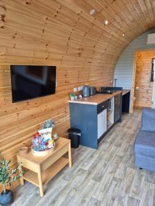 a kitchen and living room in a log cabin at Culdaff Estate Glamping in Culdaff
