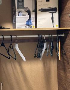 a shelf with a hair dryer and hair brushes at Entire Peaceful in Central London in London