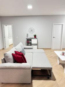 a living room with a couch with red pillows on it at Casa en Villa Romero in Alora
