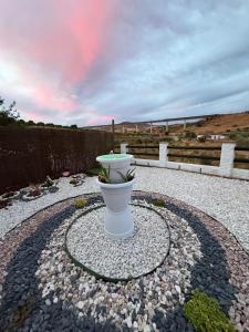 a white vase sitting on top of a stone ground at Casa en Villa Romero in Alora +11 photos