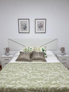 a bedroom with a large bed with two night stands at Casa en Villa Romero in Alora