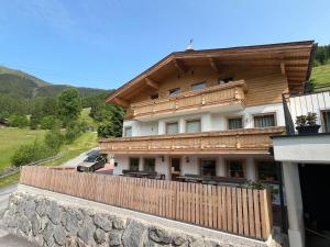 a house with a wooden fence in front of it at Chalet Kirsten in Zell am See