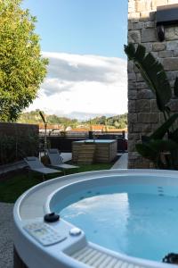 a hot tub sitting on top of a patio at Isola Degli Angeli in Figline Valdarno