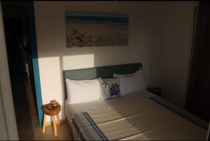 a bedroom with a bed and a small table at K Playa Vibe Darbouazza in Dar Bouazza