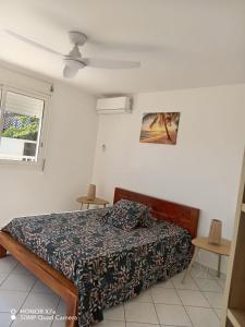 a bedroom with a bed and a window at Leu doux bruit des vagues in Saint-Leu +22 photos