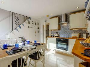a kitchen with a table with chairs and a counter top at 2 Bed in Ventnor 90147 in Ventnor +13 photos
