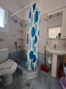 a bathroom with a shower and a toilet and a sink at Actis studios 2 in Stelida +35 photos