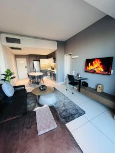 a living room with a fire on the wall at Sandton Pool View with Balcony in Johannesburg