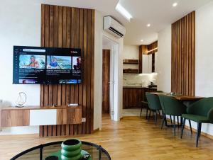 a living room with a television on a wall at CENTRAL SQUARE - Apartmani Centar Zlatibor in Zlatibor