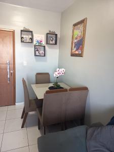 a dining room with a table and chairs and a table and a table at ApartamentoA306 in Ananindeua