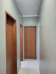 an empty hallway with a door and a tile floor at ApartamentoA306 in Ananindeua