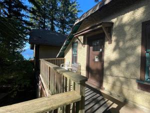 a balcony of a house with a wooden porch at Vancouver West Ocean View Villa in Vancouver