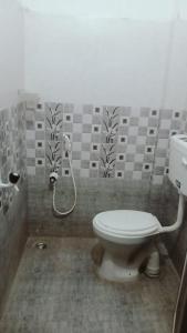 a bathroom with a toilet and a shower at Raju Residency in Visakhapatnam