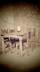 a wooden table and chairs in a room at Casa Rural Fuentetrigo in Brizuela