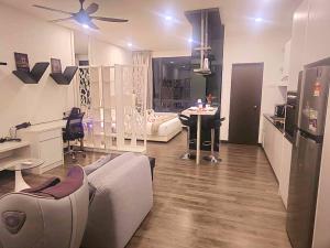 a living room with a couch and a ceiling fan at Landmark Residence 1 And 2 - Kajang in Kajang