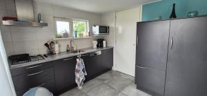 a small kitchen with a sink and a refrigerator at Alpaca World Friesland in Workum