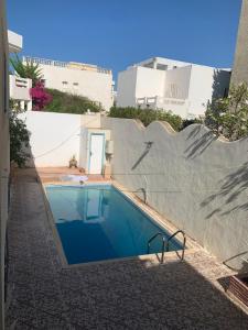 a swimming pool in the side of a building at Villa avec piscine au style Sibi Bou Saïd in Sousse