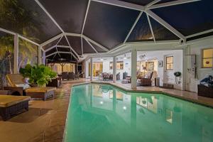 a large swimming pool in a living room at Dream Tropical Oasis 10 mins Walking to the Beach in Marco Island