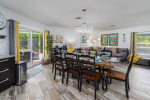 a dining room and living room with a table and chairs at Dream Tropical Oasis 10 mins Walking to the Beach in Marco Island