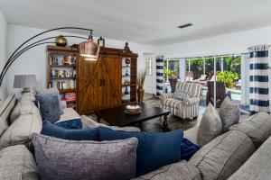 a living room with a couch and a table at Dream Tropical Oasis 10 mins Walking to the Beach in Marco Island
