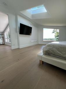 a bedroom with a bed and a flat screen tv at Country Elegance Near GTA in Schomberg +32 photos