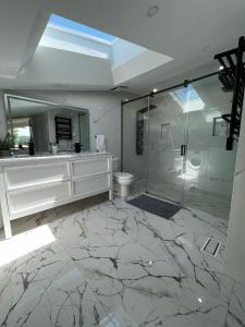 a bathroom with a shower and a toilet and a mirror at Country Elegance Near GTA in Schomberg