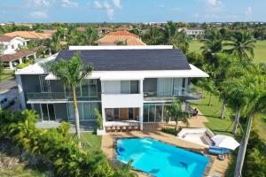 an aerial view of a house with a swimming pool at Elysium Suits Maximum Comfort in Punta Cana