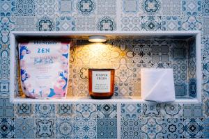 a shelf with a bottle of wine and a napkin at Studio Bleu by The Prime Escape in Arusha