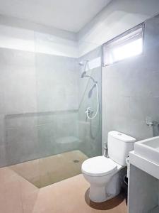 a bathroom with a shower and a toilet and a sink at Bali Bliss Residence in Seminyak