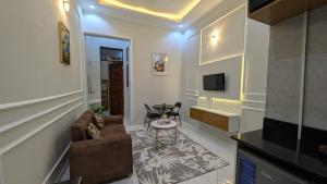 a living room with a couch and a table at Mielz Apartment in Dar es Salaam