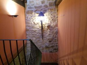 a hallway with a lamp next to a stone wall at Carpe Diem in Navaridas