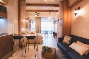 a kitchen and living room with a couch and a table at Mediterranean Apartment, CB510 in Estación El Salto