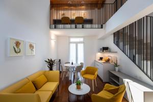 a living room with a yellow couch and a table at Grow Green in Caponago