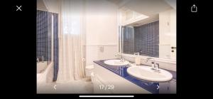 a white bathroom with two sinks and a mirror at Residence La Pineta a 500 mt dal mare Versilia in Le Focette +22 photos