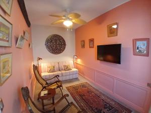 a living room with a couch and a flat screen tv at La Résidence des Indes in La Rochelle