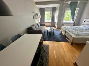 a living room with a bed and a couch at Skarholmen Stockholm Apartment in Stockholm