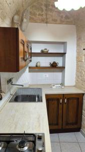 a kitchen with a sink and a counter top at Da Nonna Filomena in Alberobello