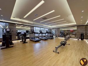 a gym with treadmills and exercise equipment in a building at Vogue Vacation Homes, Business Bay Damac Cour Jardin close to Downtown, Burj Khalifa and Dubai Mall, Studio Apartment with City View, Access to all Amenities in Dubai