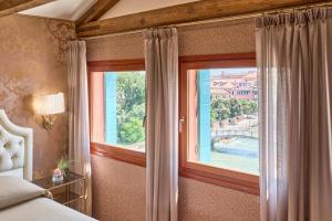 a bedroom with a window with a view of a pool at Hotel Santa Chiara in Venice