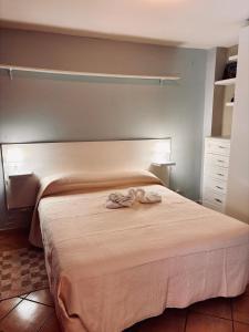 Ένα ή περισσότερα κρεβάτια σε δωμάτιο στο La casetta di Nonna Rosa