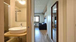 a bathroom with a sink and a mirror at Hostdomus - Rainbow Apartment in Sestriere +8 photos
