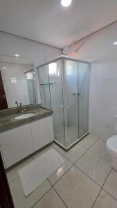 a bathroom with a shower and a sink and a toilet at Club Meridional Carneiros 01PS Pé na Areia by LP in Tamandaré