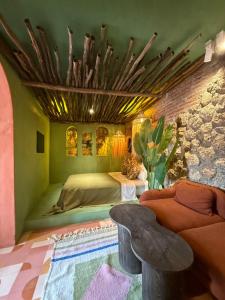 a bedroom with a bed and a couch and a table at Casa Amina in Chefchaouene