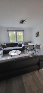 a living room with a couch and chairs and tables at Apartman Lala in Sarajevo