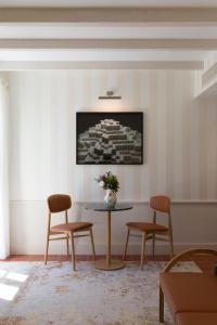 a living room with a table and two chairs at Hôtel Maison Borrèze in Souillac